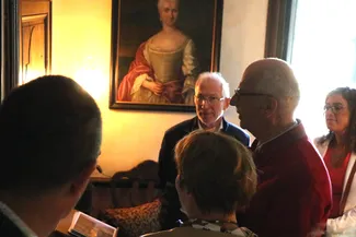 Gilles Pirlot de Corbion raconte la curieuse histoire du tableau du peintre Louis-Félix Rhenasteine représentant le chirurgien Erasme Gillard qui pose la main sur un ouvrage de Pierre Dionis. Ⓒ 2025 CC BY-NC 4.0 Didier Misson Devant le portrait de Marie Anne Laurenty, épouse d’ Erasme Gillard, Jean-Pierre Dardenne et Coralie Bonnet écoutent les explications de Gilles Pirlot de Corbion à propos de l’ouvrage de Pierre Dionis